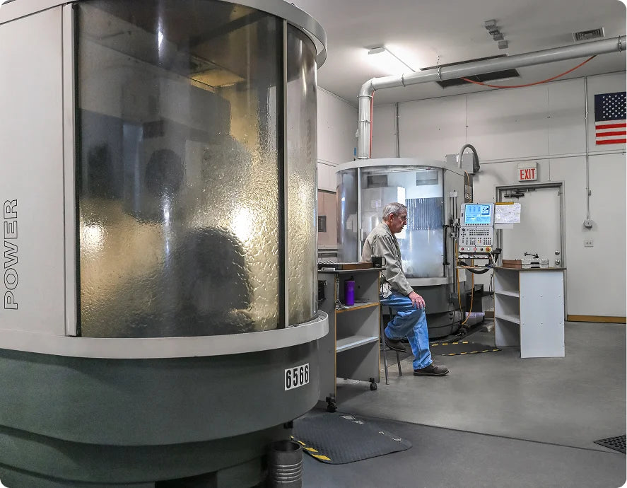 Industrial CNC machine operator in manufacturing workshop